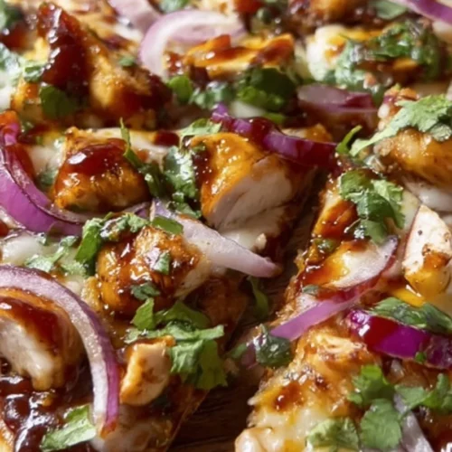 BBQ chicken flatbread topped with fresh ingredients and herbs