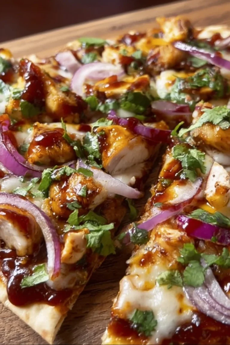 BBQ chicken flatbread topped with fresh ingredients and herbs