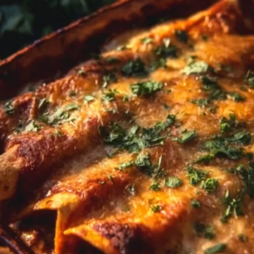 Delicious ground beef enchiladas topped with cheese and fresh herbs