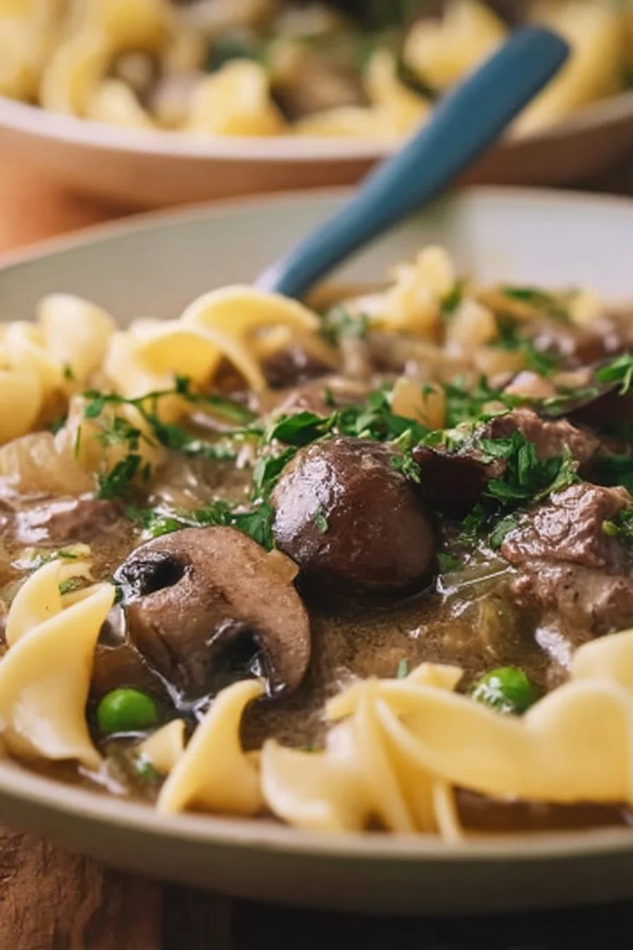 Delicious Beef Stroganoff Soup in a bowl with fresh herbs garnish.