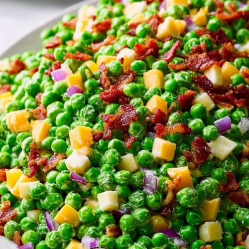 Classic English Pea Salad with fresh peas, onions, and creamy dressing