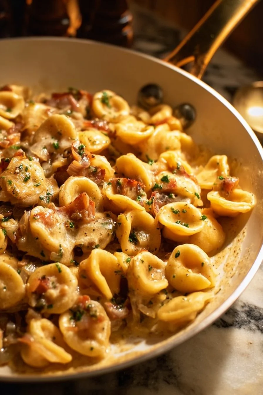 Delicious plate of French onion pasta topped with melted cheese and caramelized onions