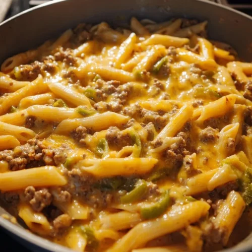Bowl of Homemade Green Chile Hamburger Helper served with a side of vegetables