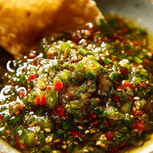 A vibrant bowl of homemade jalapeno salsa with cilantro and lime.