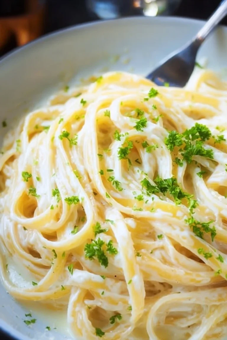 Creamy Olive Garden Alfredo sauce served over fettuccine pasta