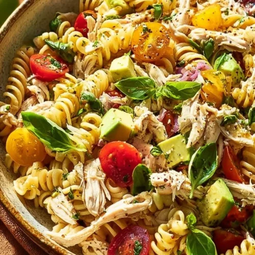 Delicious and fresh chicken pasta salad in a bowl with vegetables and dressing