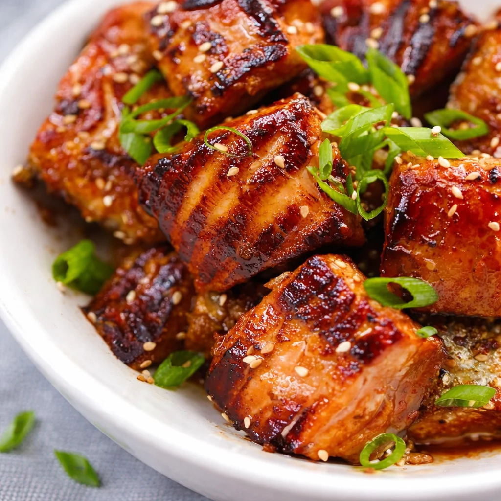 Easy crispy salmon bites appetizer served with a tangy harissa-yogurt sauce.