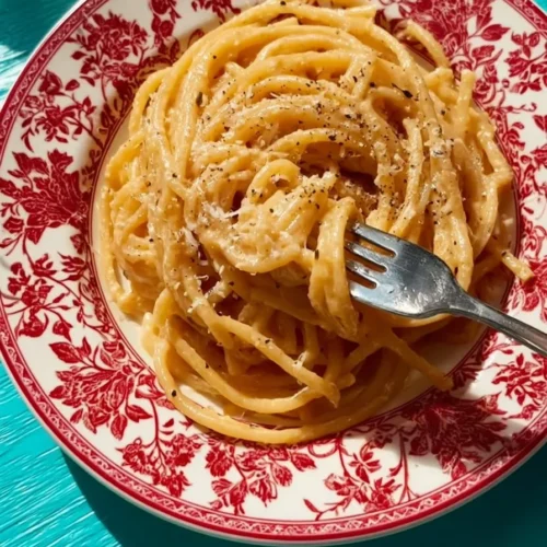 Bowl of delicious miso pasta garnished with green onions and sesame seeds