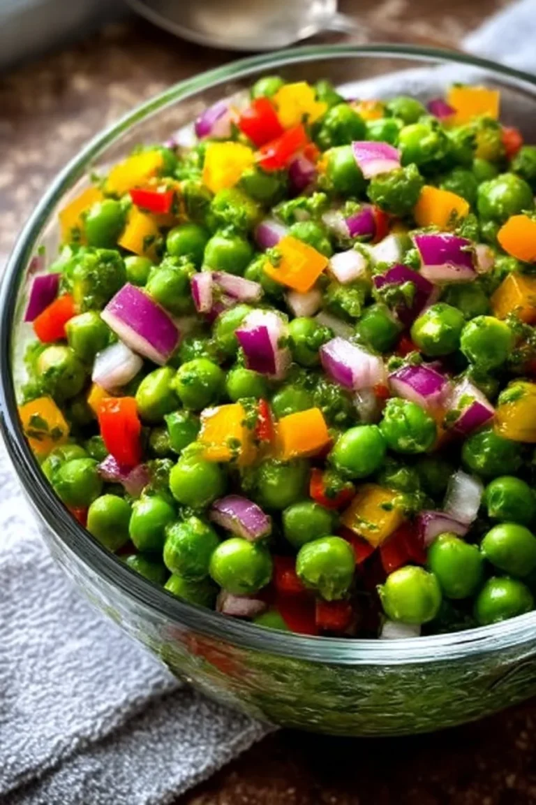 Fresh and vibrant pea salad topped with herbs and dressing