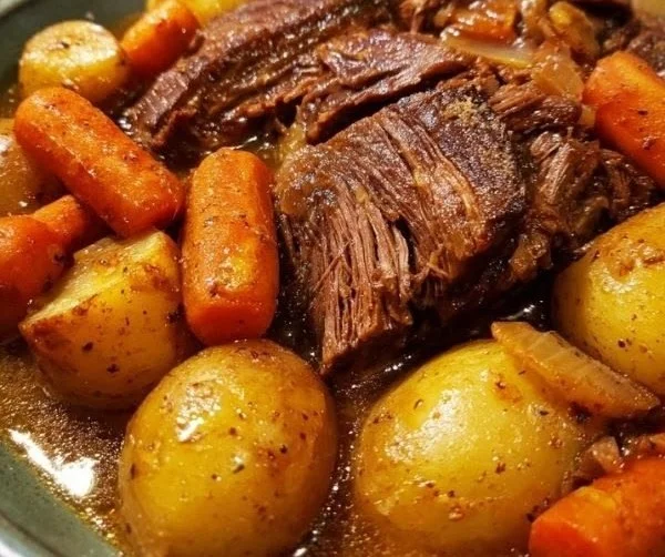 Delicious pot roast served with vegetables and gravy