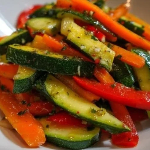 Colorful sautéed vegetables in a skillet, showcasing vibrant bell peppers and broccoli.